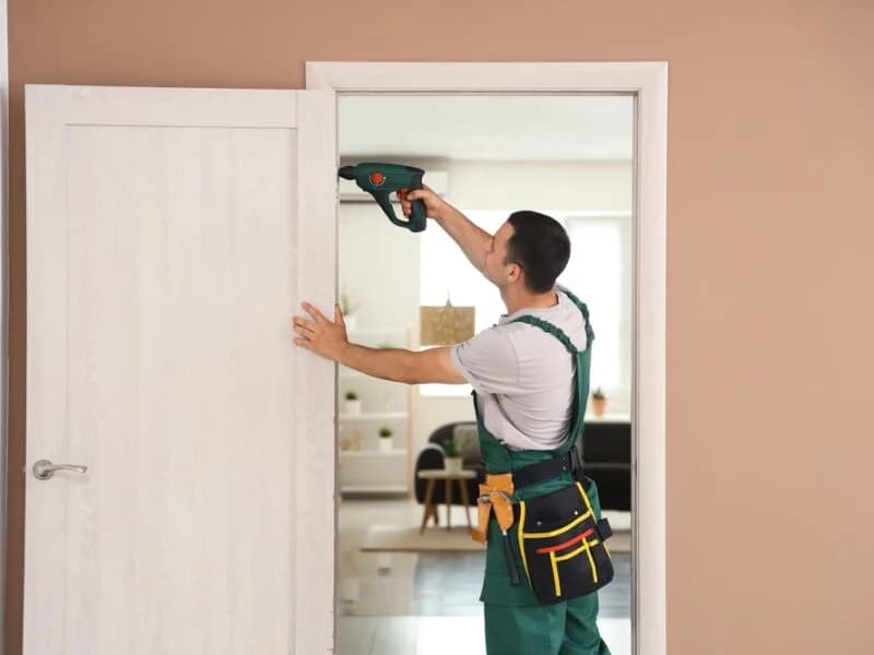 Contractor carrying out communal area maintenance and repairs at a residential block