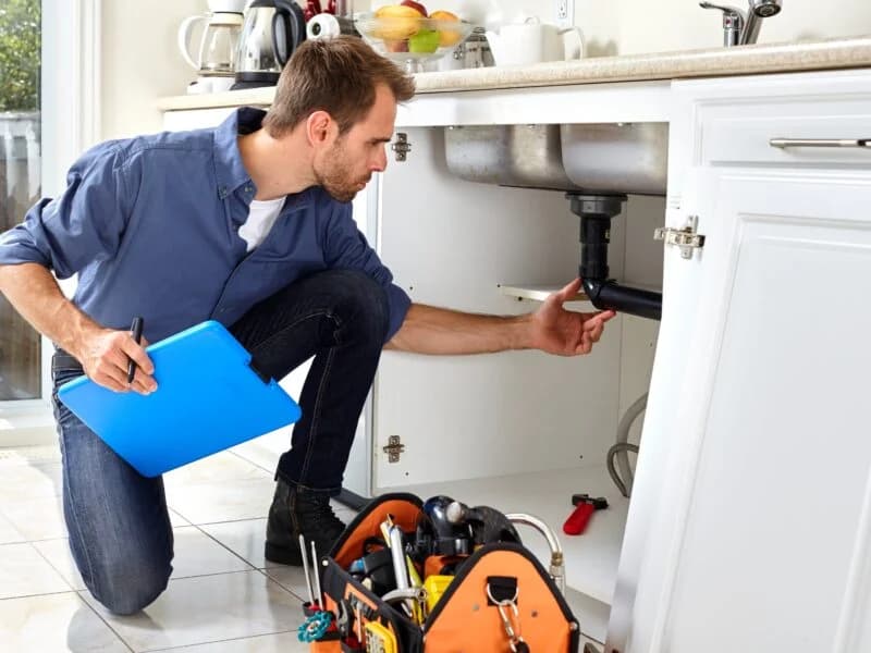 Plumber carrying out maintenance repairs at a London rental property